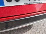 a close up of a red car with a number plate on it