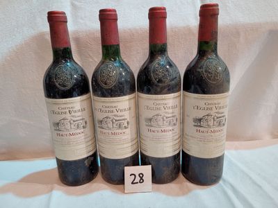 three bottles of red wine are lined up on a table