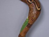 an image of a snake on a stick on a table