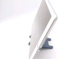 a tablet computer sitting on a stand on a white surface