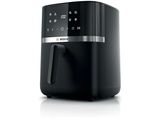 a close up of a black air fryer on a white surface