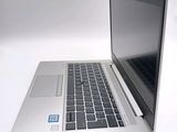 a silver laptop with a blue sticker on it