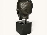 an image of a sculpture of a man ' s head on a black stand