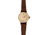 a close up of a watch on a white background with a brown strap