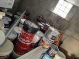 many cans of paint and cans of paint in a room