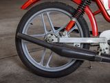 a red and white motorcycle parked in a garage