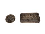 an image of a small metal box sitting next to a small metal object