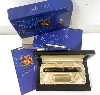a box with a pen and a notepad inside of it