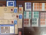 a lot of stamps on the table and a lot of envelopes