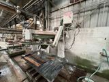 a machine that is working on a piece of wood in a factory