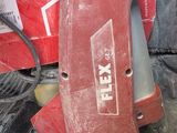 a red corded sander sitting on top of a pile of tools