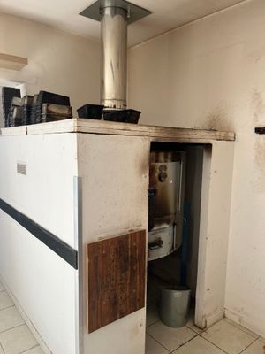 an image of a kitchen with a stove in the corner
