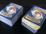 two packs of pokemon cards sitting on top of each other