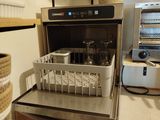 a kitchen with a stove and a dishwasher on the counter