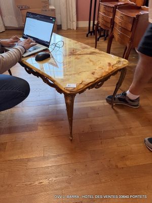 a man sitting at a table with a laptop on it