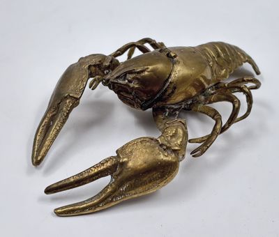 brass plated lobster on a white background