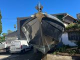 a boat sitting on top of a pole in a parking lot