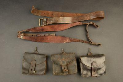 several different types of leather items are laid out on a table