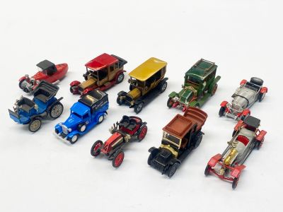 a lot of toy cars that are on a white surface