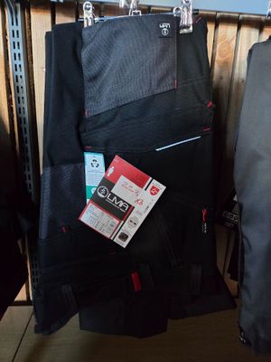 two pieces of luggage that are hanging on a rack