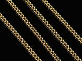 a close up of a gold chain on a black background