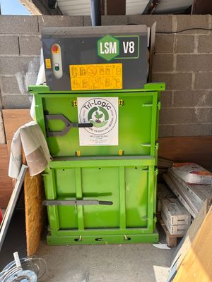 a green machine that is sitting in a garage
