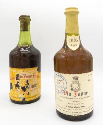 two bottles of wine sitting next to each other on a white surface