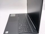 a laptop with a black keyboard sitting on a white surface