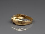an image of a gold ring with a knot around the band