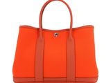 a large orange handbag on a white background