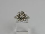 a diamond ring with a center stone surrounded by diamonds