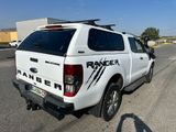 a white pick up truck parked on the side of the road