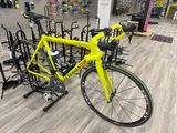 a yellow bike that is sitting in a bike rack