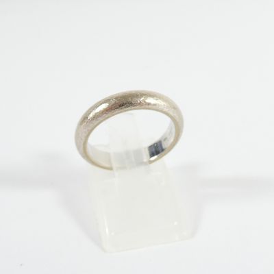 a close up of a silver ring on a white surface