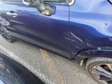a blue car with a bird on top of it