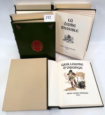 three books are sitting on a table with a white table cloth