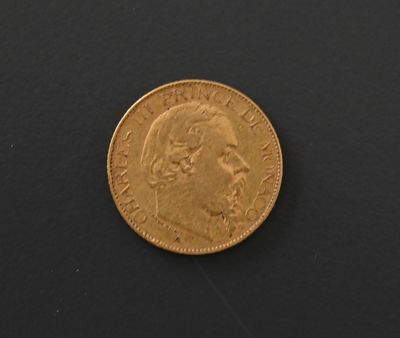 a close up of a gold coin on a black surface