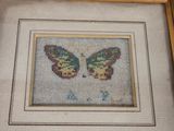 an old picture of a picture of a butterfly in a frame