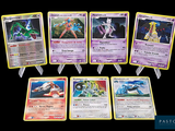 several pokemon cards are lined up in a row on a black background