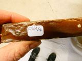 a person holding a piece of chocolate with a sticker on it