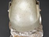 an image of a helmet on a plastic stand on a black background