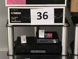 a shelf with a television and other electronics on top of it