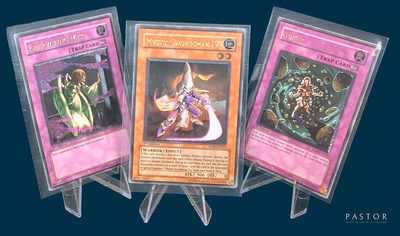 three cards are displayed in plastic holders on a blue background