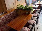 many tables and chairs in this restaurant with a lot of windows