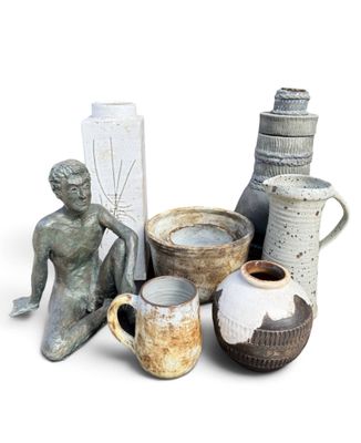 many vases that are sitting on a white surface