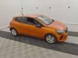 the orange car is parked in the garage on the checkered floor