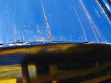 a close up of a blue and yellow train on the tracks