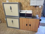 two cupboards and a cabinet in a room