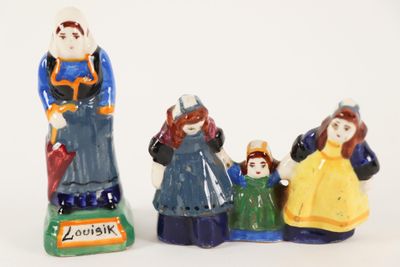 three figurines of people that are standing next to each other