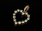 a gold heart shaped pendant with diamonds on a black background